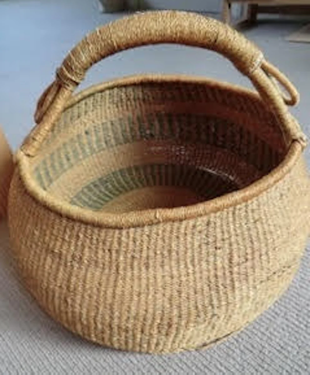Traditional Bolga basket purchased in Bolgatanga, Ghana, in the 1960s, showing its woven structure and handles after more than sixty years.